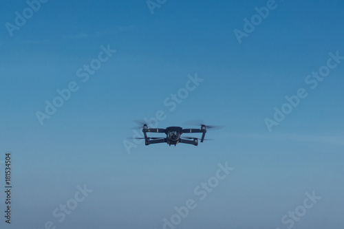 black drone with camera flying
