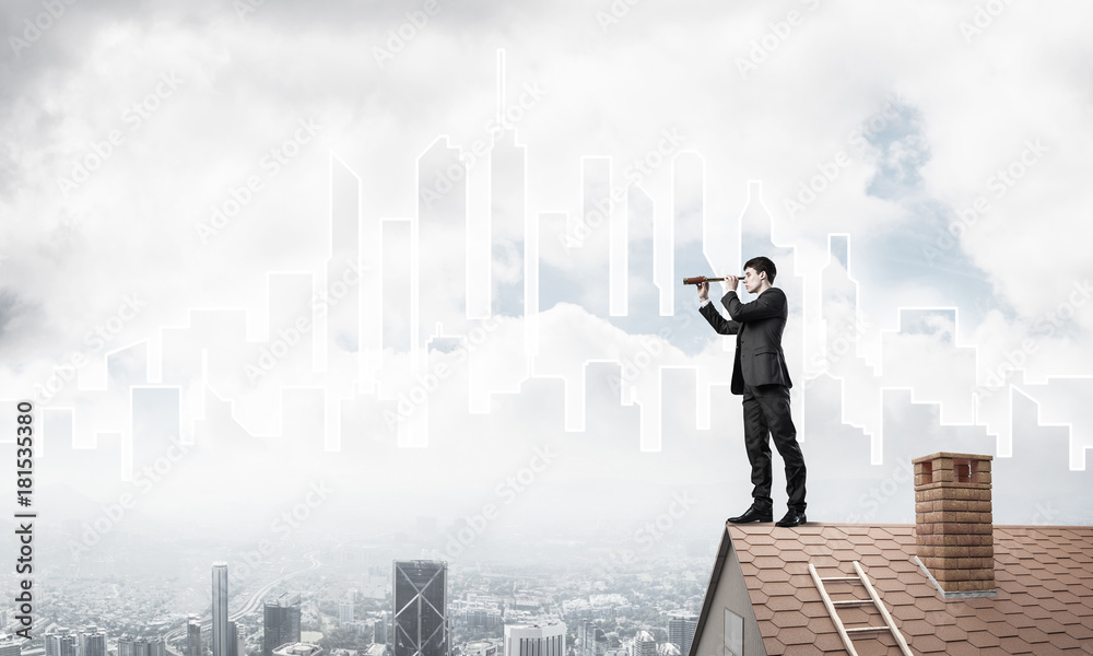 Engineer man standing on roof and looking in spyglass. Mixed med Engineer man standing on roof and looking in spyglass. Mixed med