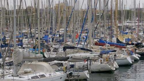 BARCELONA, SPAIN, SEPTEMBER 22, 2017: Parked Ships, Boats, Yachts in the Port Vell of Barcelona, Spain. Panoramic view of the ships parked in the port of Rambla del Mar. View of the pier from the