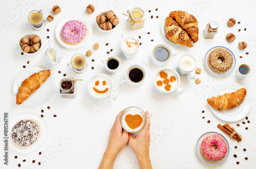 White background with woman's hand and different types of coffee and desserts to them © nata_vkusidey