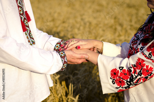 couple in traditional attire holding hands