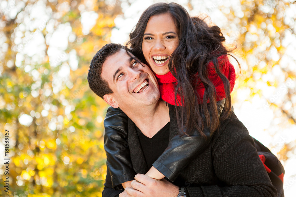 Amazing funny young couple in autumn park having fun Amazing funny young couple in autumn park having fun
