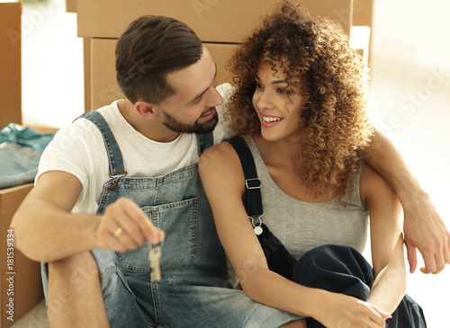 Newlyweds talking while sitting near cardboard boxes