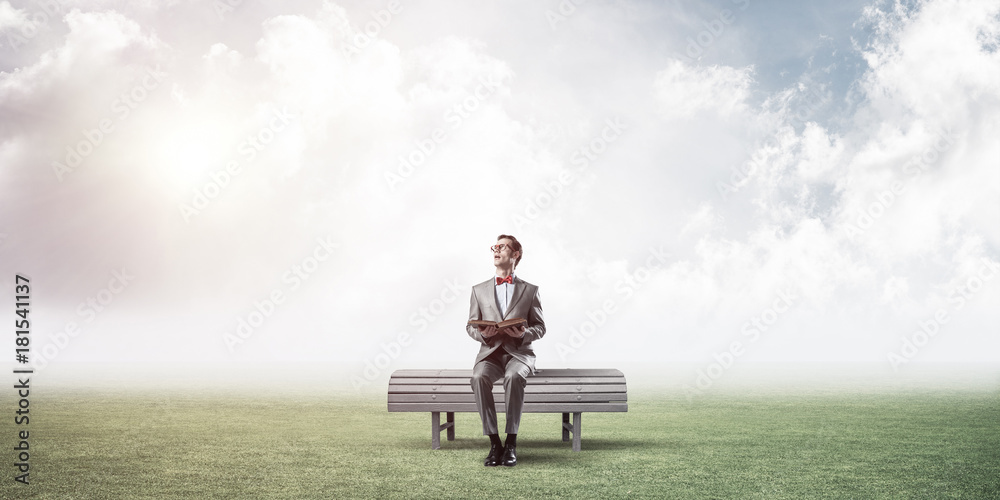 Young businessman or student studying the science in summer park