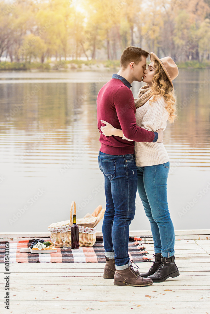 Love You So much. Full-length of young man embracing and kissing his  beautiful girlfriend while standing outdoors. Young couple hugging and  kissing while having romantic date on coastline. Photos | Adobe Stock