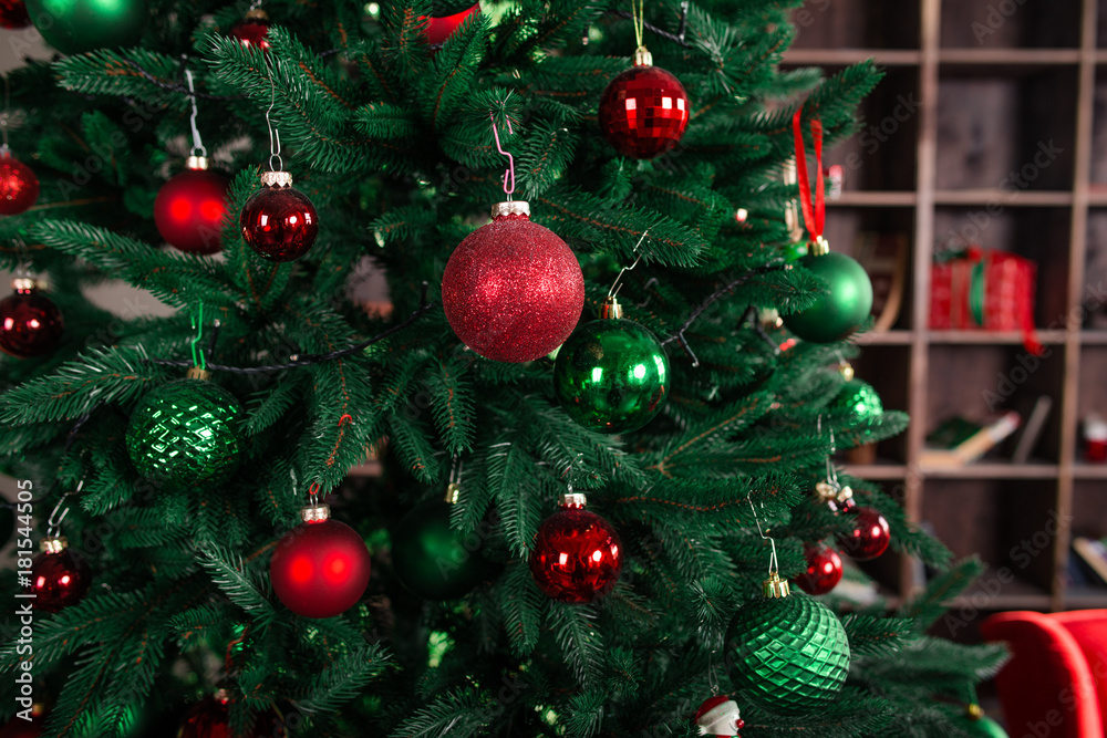 Fototapeta premium new year tree with decorations, red sofa, bookshelf, present boxes