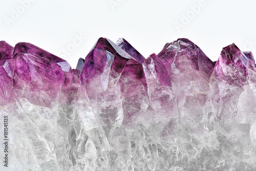 Crystal Stone macro mineral, purple rough amethyst quartz crystals on white background photo