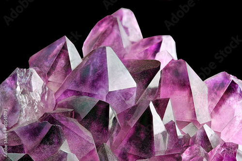 Crystal Stone macro mineral, purple rough amethyst quartz crystals on black background