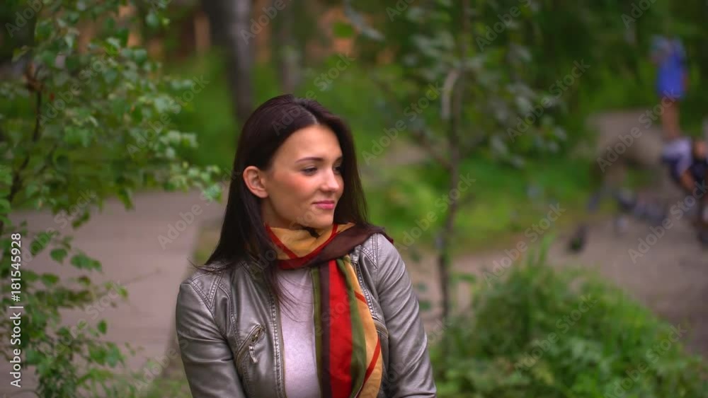 Close up of young woman, beautiful brunette woman smiling in summer park. 4 k Close up of young woman, beautiful brunette woman smiling in summer park. 4 k