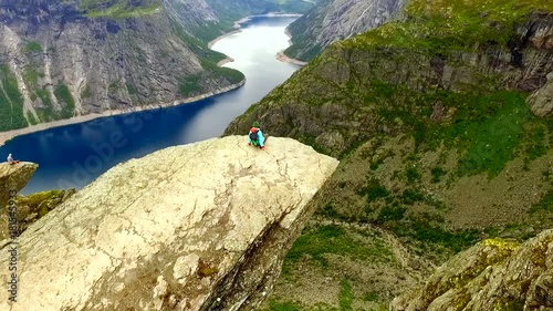 Trolltunga. Norway. girl sitting on the edge of the Trolltunga. aerial vie. beautiful landscape of Norway