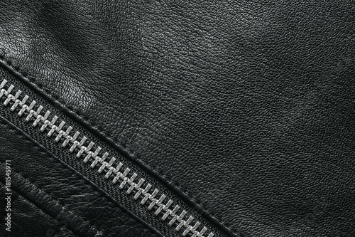 Black leather empty copy space background with metal zipper in the corner.