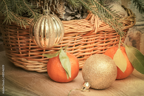 Christmas balls and tangerines on a background of a basket