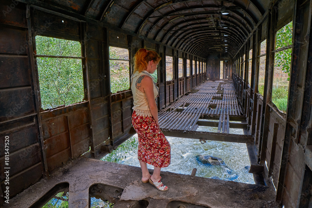 Woman inside bridge made from old abandoned train car in Georgia