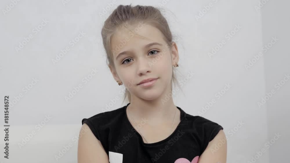 happy little cute girl woke up in white bed, smiling kid child model face pretty beautiful schoolgirl