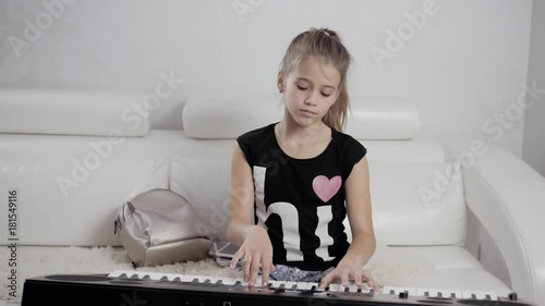 Girl's hands on the keyboard of the piano. The girl plays piano,close up piano. Hands on the white keys of the Piano Playing a Melody. Women's Hands on the keyboard, Playing the Notes Melody. photo