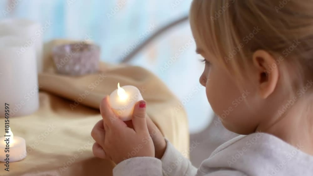 The girl lights up electric candles and puts on the table The girl lights up electric candles and puts on the table