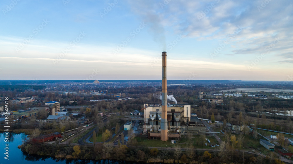 Obraz premium Garbage incineration plant. Waste incinerator plant with smoking smokestack. The problem of environmental pollution by factories.