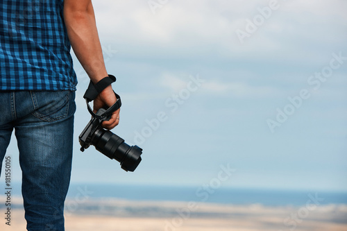 Professional camera in man's hand