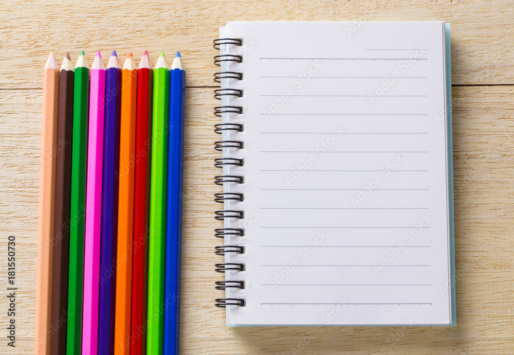 book, diary and crayon on table book, diary and crayon on table