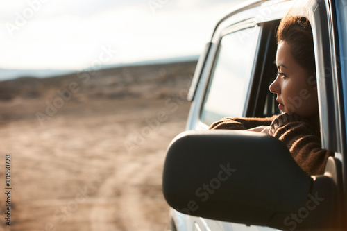 Woman looking out the window of her car
