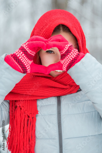 Woman hands in red winter gloves. Heart symbol shaped Lifestyle and Feelings concept.
