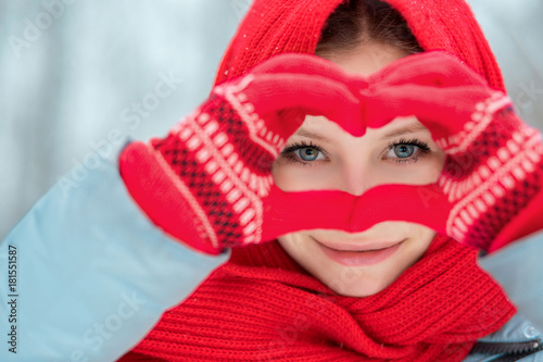 Woman hands in red winter gloves. Heart symbol shaped Lifestyle and Feelings concept.
