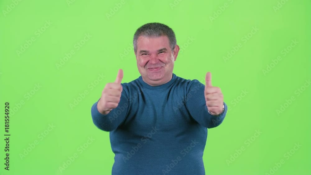 Middle aged man is showing a thumbs up. Green screen Middle aged man is showing a thumbs up. Green screen