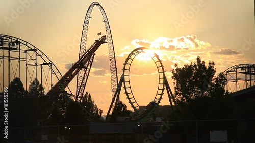 Wide, sunset over roller coaster ride