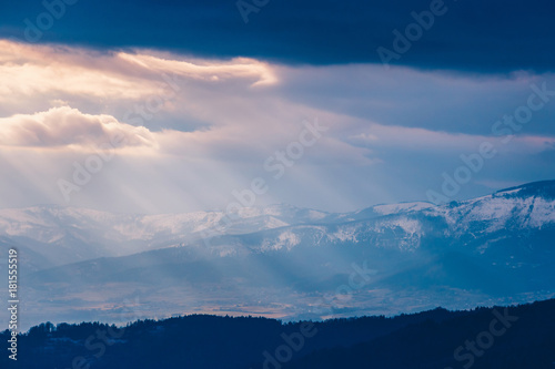Rays of light pass through the clouds, mountain landscape