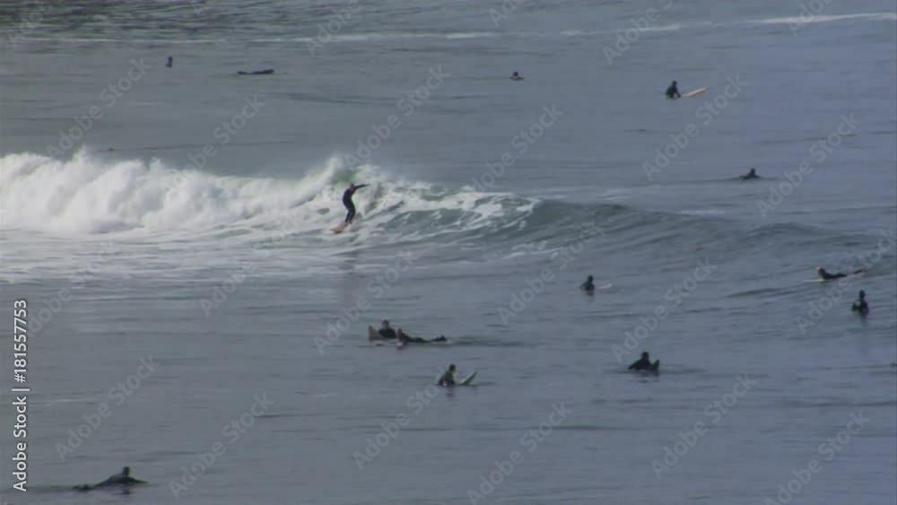 Wide, crowded cove of surfers