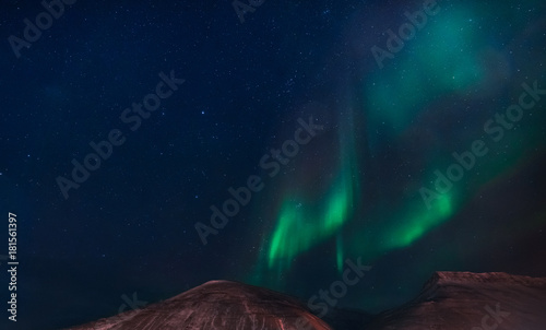 The polar arctic Northern lights aurora borealis sky star in Norway Svalbard in Longyearbyen city mountains photo