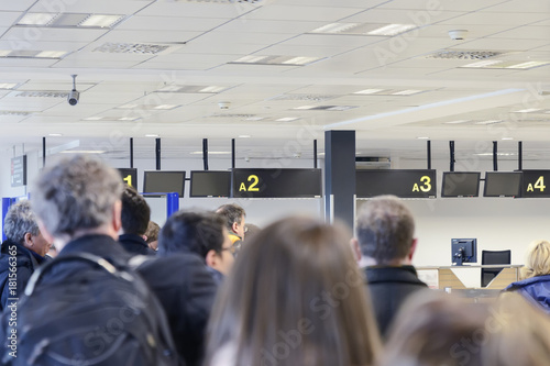 group of people awaiting registration at the airport building