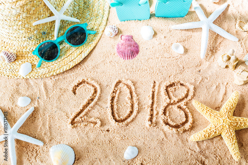 2018 text in the sand with beach accessories