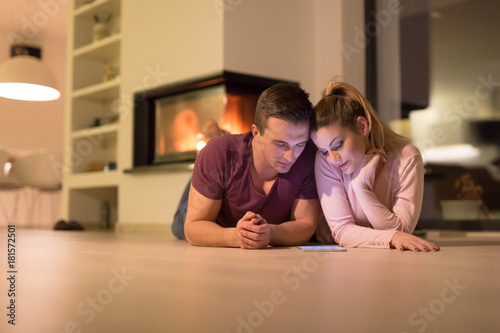 Young Couple using digital tablet on cold winter night
