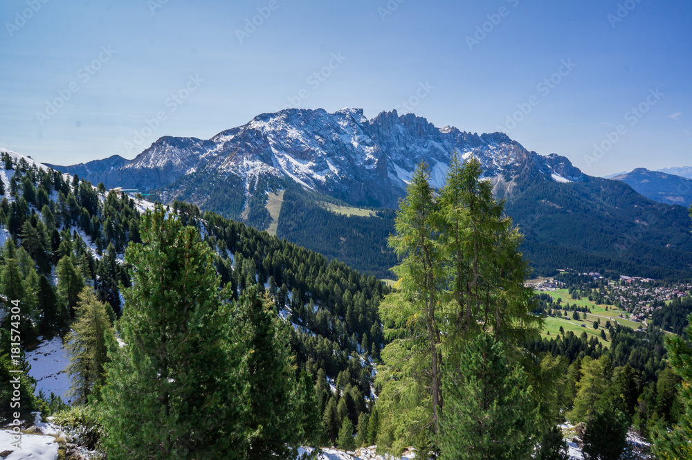 Snow mountains and green valley at summer sunny day. Dolomites Alps, Rosengarden Group, South Tirol, Italy.