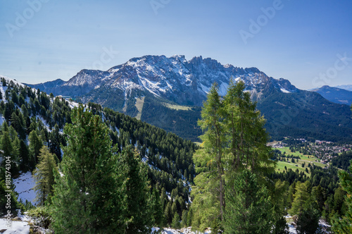 Snow mountains and green valley at summer sunny day. Dolomites Alps, Rosengarden Group, South Tirol, Italy. photo