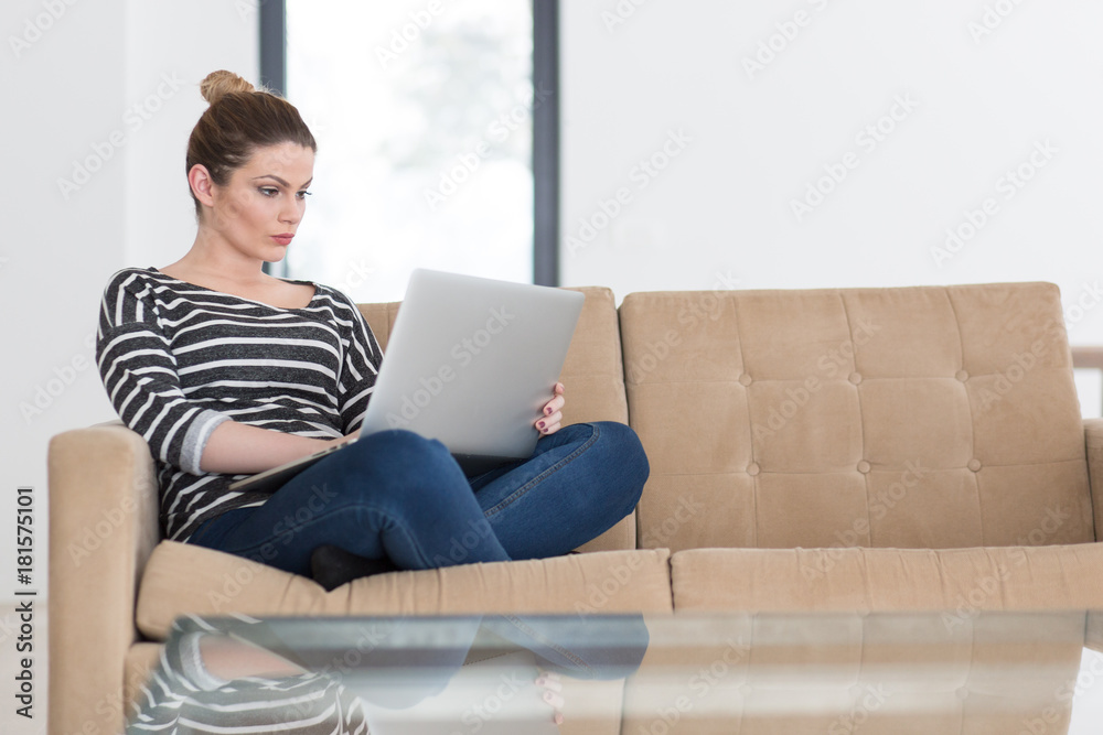 young woman on sofa at home websurfing young woman on sofa at home websurfing