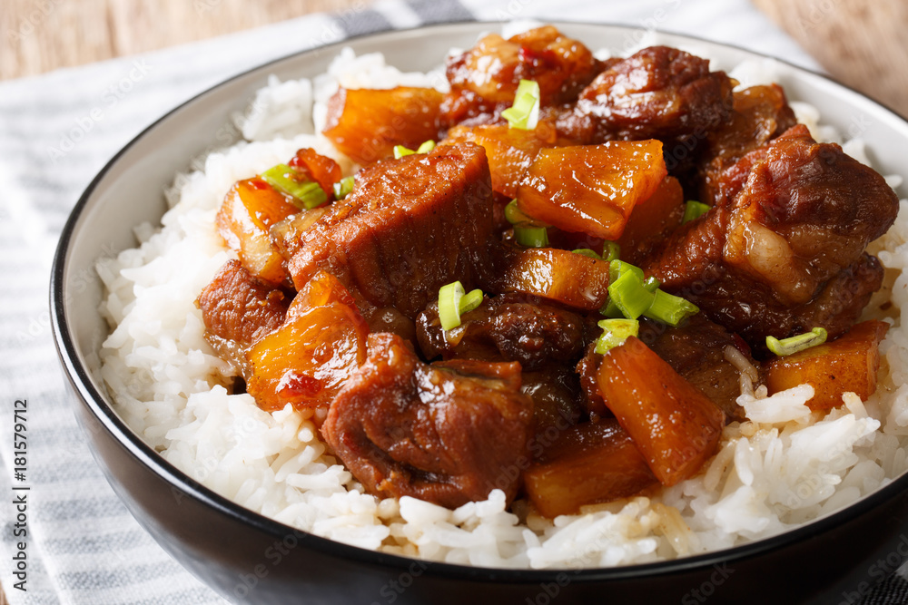 Tasty Filipino pork hamonado in pineapple juice with rice close-up. horizontal Tasty Filipino pork hamonado in pineapple juice with rice close-up. horizontal