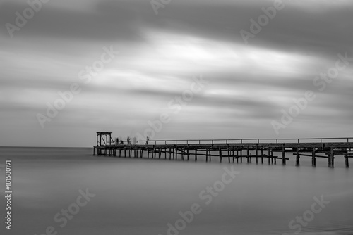 a bridge with fishermen in the sea, Atlit, Israel. Black and white photo