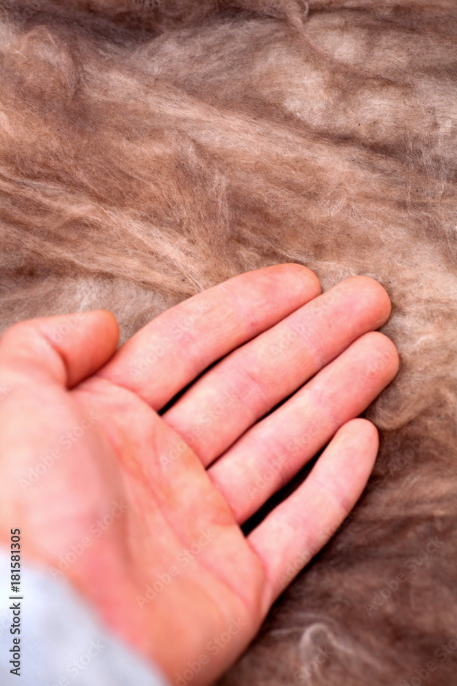 Fototapeta premium Mineral wool stack on construction site - thermal insulation of a house Soft eco-friendly insulation for the roof is safe for the hands skin