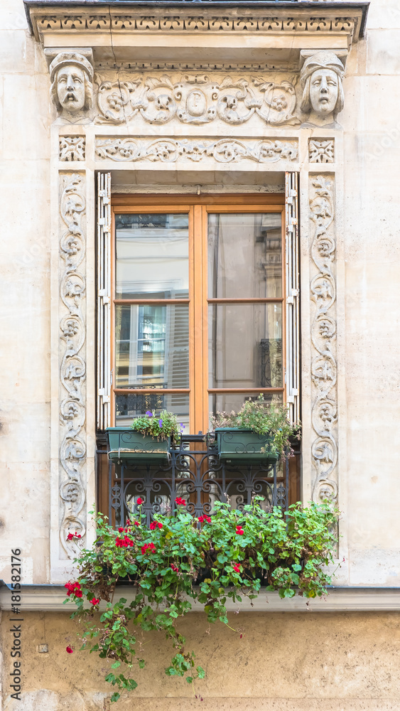 Paris, typical window with sculptures carved around
