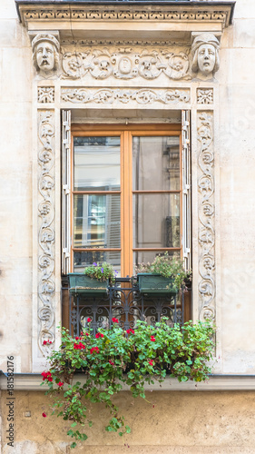 Paris, typical window with sculptures carved around 
