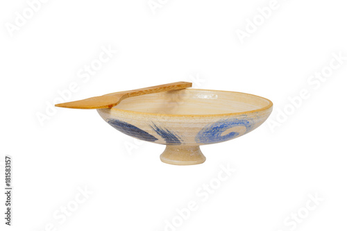 old Pottery bowl and bamboo paddle on white background