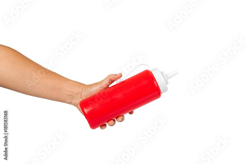 ketchup source bottle in hand on white background.