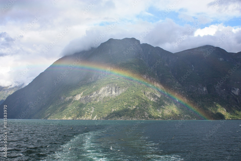 rainbaw over the lake in the mountains of norway