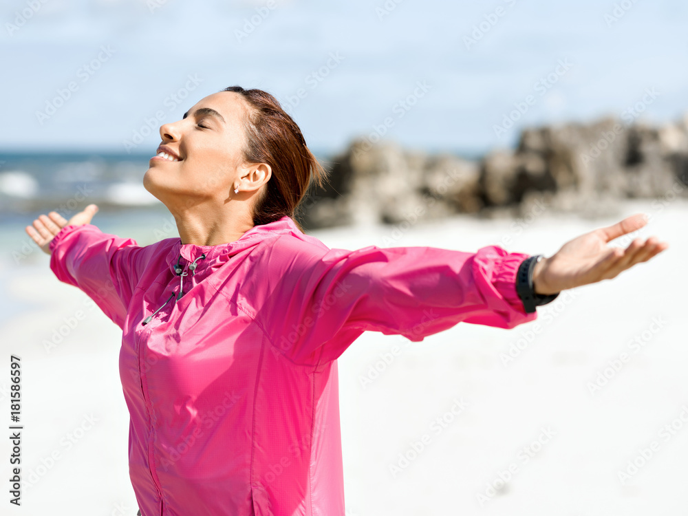 Athletic woman in sportswear standing at the seaside Athletic woman in sportswear standing at the seaside