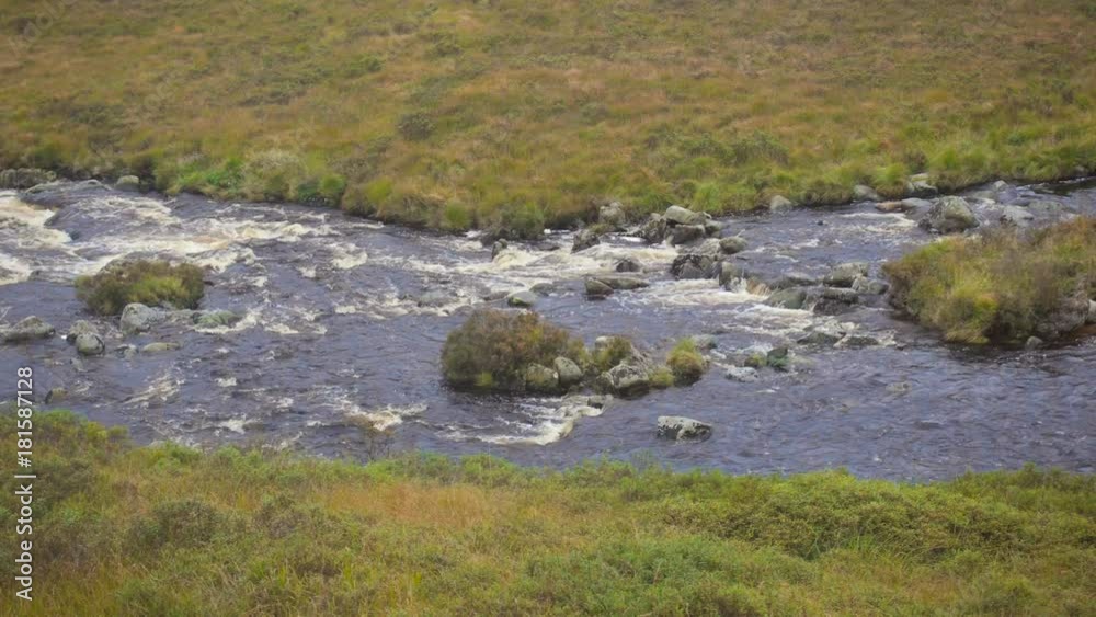 Wild River in a Valley in the Scottish Highlands After the Rain Wild River in a Valley in the Scottish Highlands After the Rain