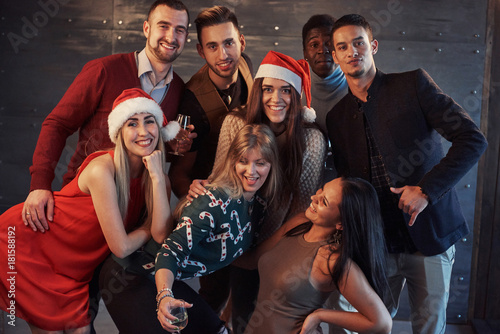 New Year is coming! Group of cheerful young multiethnic people in Santa hats on the party, posing emotional lifestyle people concept
