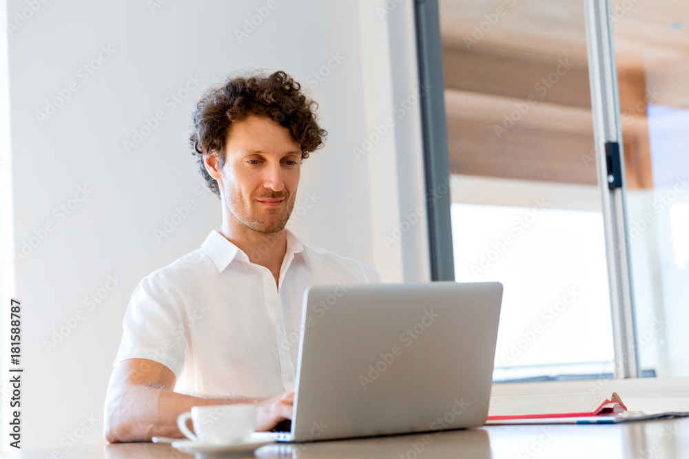 Man working on laptop at home Man working on laptop at home