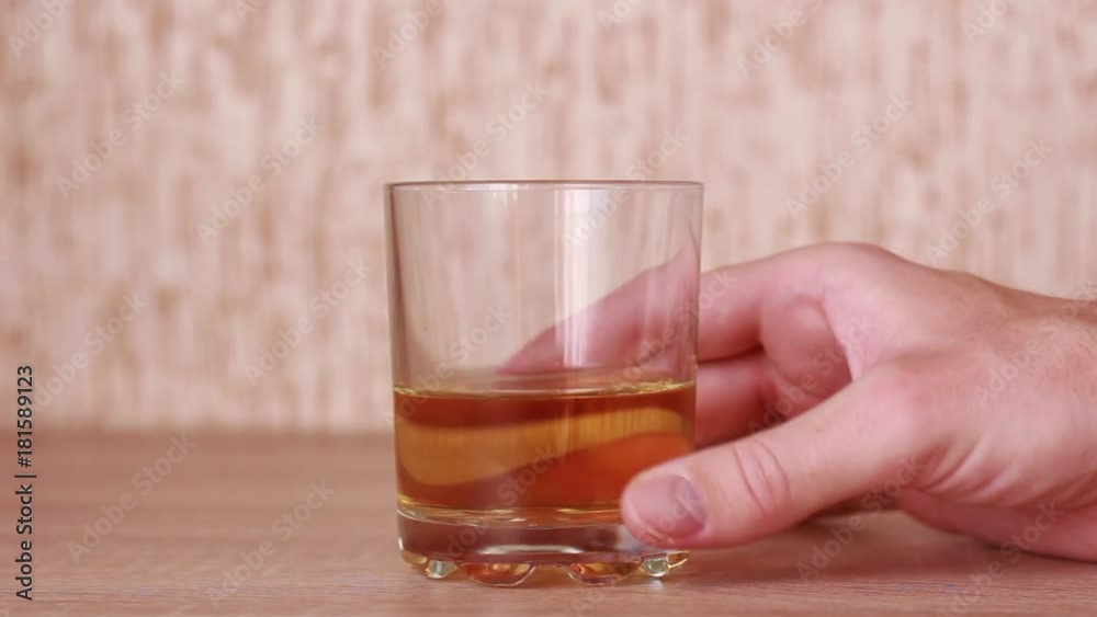 Putting cigarette over the glass of whiskey Putting cigarette over the glass of whiskey